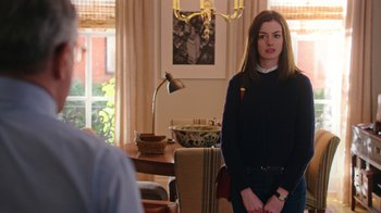 Movie still from “The Intern” (2015), directed by Nancy Meyers – A woman standing in front of a man in a living room; Medium shot, Over the shoulder angle