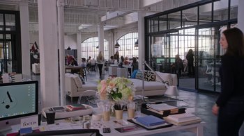 Movie still from “The Intern” (2015), directed by Nancy Meyers – A room filled with lots of furniture and people in it; Wide shot, High angle