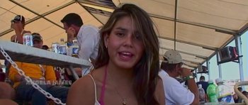 Movie still from “The Jewel Thief” (2023), directed by Landon Van Soest – A young woman with long brown hair wearing a pink top; Close Up shot, High angle