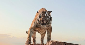 Movie still from “The Jungle Book” (2016), directed by Jon Favreau – A tiger standing on top of a rock; Wide shot, Low angle