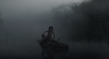 Movie still from “The Jungle Book” (2016), directed by Jon Favreau – A woman sitting on a raft in a body of water; Wide shot, High angle