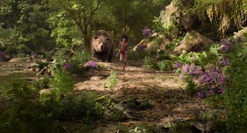 Movie still from “The Jungle Book” (2016), directed by Jon Favreau – A man and a bear in the woods; Extreme Wide shot, High angle