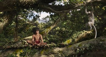 Movie still from “The Jungle Book” (2016), directed by Jon Favreau – A child sitting on the ground under a large tree; Wide shot, Low angle