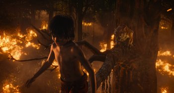 Movie still from “The Jungle Book” (2016), directed by Jon Favreau – A young boy is running through the jungle; Wide shot, High angle