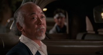 Movie still from “The Karate Kid Part II” (1986), directed by John G. Avildsen – An older man sitting in front of a mirror; Close Up shot, Over the shoulder angle