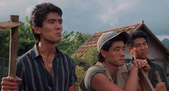 Movie still from “The Karate Kid Part II” (1986), directed by John G. Avildsen – Two asian men standing next to each other in front of a building; Close Up shot, Low angle