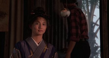 Movie still from “The Karate Kid Part II” (1986), directed by John G. Avildsen – A woman in a kimono standing in front of a man; Medium shot, Over the shoulder angle