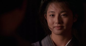 Movie still from “The Karate Kid Part II” (1986), directed by John G. Avildsen – A woman's face in the dark; Close Up shot, Over the shoulder angle