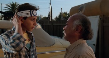 Movie still from “The Karate Kid Part III” (1989), directed by John G. Avildsen – A man and a young boy talking to each other; Close Up shot, Over the shoulder angle