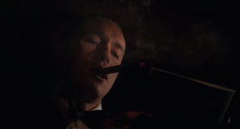 Movie still from “The Karate Kid Part III” (1989), directed by John G. Avildsen – A man in a suit smoking a cigarette; Close Up shot, Low angle