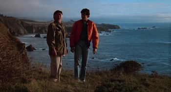 Movie still from “The Karate Kid Part III” (1989), directed by John G. Avildsen – Two people standing on a hill near the ocean; Wide shot, Low angle