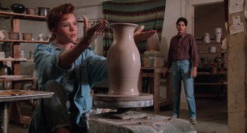 Movie still from “The Karate Kid Part III” (1989), directed by John G. Avildsen – A woman and a man working on a vase in a pottery studio; Medium shot, Over the shoulder angle