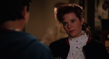 Movie still from “The Karate Kid Part III” (1989), directed by John G. Avildsen – A woman in a white shirt and a black jacket; Close Up shot, Over the shoulder angle