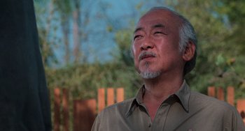 Movie still from “The Karate Kid Part III” (1989), directed by John G. Avildsen – An older asian man looking up into the sky; Close Up shot, Low angle