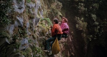 Movie still from “The Karate Kid Part III” (1989), directed by John G. Avildsen – A man and a woman climbing up a rock wall; Wide shot, Overhead angle
