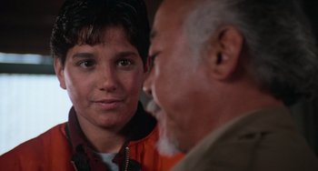 Movie still from “The Karate Kid Part III” (1989), directed by John G. Avildsen – An older man talking to a young boy; Close Up shot, Over the shoulder angle