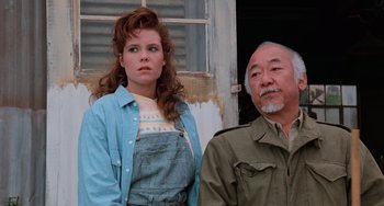 Movie still from “The Karate Kid Part III” (1989), directed by John G. Avildsen – A man and a woman standing next to each other in front of a building; Close Up shot, Low angle