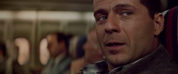Movie still from “Die Hard” (1988), directed by John McTiernan – A man's eyes and face; Close Up shot, Over the shoulder angle