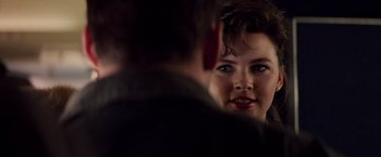 Movie still from “Die Hard” (1988), directed by John McTiernan – A woman looking at a man in the mirror; Close Up shot, Over the shoulder angle