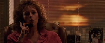 Movie still from “Die Hard” (1988), directed by John McTiernan – A woman sitting in a chair talking on the phone; Close Up shot, Low angle