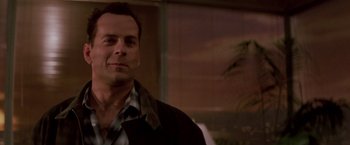 Movie still from “Die Hard” (1988), directed by John McTiernan – A person wearing a shirt and jacket; Close Up shot, Low angle