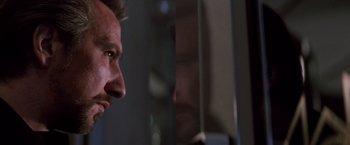 Movie still from “Die Hard” (1988), directed by John McTiernan – A man's face in front of a mirror; Close Up shot, Low angle