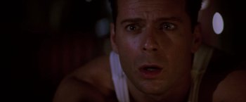Movie still from “Die Hard” (1988), directed by John McTiernan – A man's face as he stares into the camera; Close Up shot, Low angle