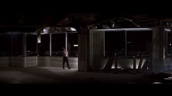 Movie still from “Die Hard” (1988), directed by John McTiernan – A man standing in front of a window at night; Extreme Wide shot, High angle