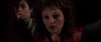 Movie still from “Die Hard” (1988), directed by John McTiernan – A person with curly hair; Close Up shot, Over the shoulder angle