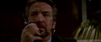 Movie still from “Die Hard” (1988), directed by John McTiernan – A person holding a microphone; Close Up shot, Low angle