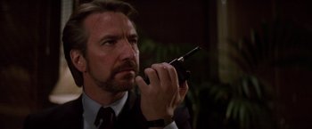 Movie still from “Die Hard” (1988), directed by John McTiernan – A person holding a cell phone; Close Up shot, Low angle