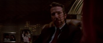 Movie still from “Die Hard” (1988), directed by John McTiernan – A person wearing a suit and tie; Close Up shot, Low angle