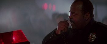 Movie still from “Die Hard” (1988), directed by John McTiernan – A person holding a cell phone; Close Up shot, Low angle