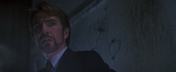 Movie still from “Die Hard” (1988), directed by John McTiernan – A person wearing a suit and tie; Close Up shot, Low angle