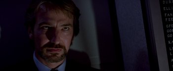 Movie still from “Die Hard” (1988), directed by John McTiernan – A person wearing a suit and tie; Close Up shot, Low angle