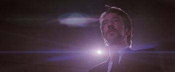 Movie still from “Die Hard” (1988), directed by John McTiernan – A person wearing a suit and tie; Close Up shot, Low angle