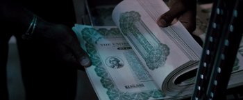 Movie still from “Die Hard” (1988), directed by John McTiernan – A person is holding an open book with an image on it; Extreme Close Up shot, High angle