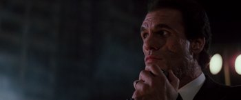 Movie still from “Die Hard” (1988), directed by John McTiernan – A person with his hand under his chin; Close Up shot, Low angle