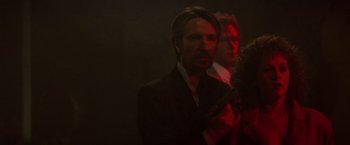 Movie still from “Die Hard” (1988), directed by John McTiernan – A man in a suit and tie holding a gun; Close Up shot, Low angle