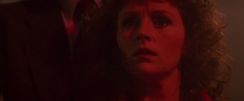Movie still from “Die Hard” (1988), directed by John McTiernan – A woman's face in a red light; Close Up shot, Low angle