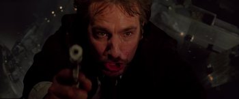 Movie still from “Die Hard” (1988), directed by John McTiernan – A person holding a gun; Close Up shot, Low angle