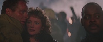 Movie still from “Die Hard” (1988), directed by John McTiernan – A person with curly hair; Close Up shot, Over the shoulder angle