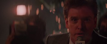 Movie still from “Die Hard” (1988), directed by John McTiernan – A person wearing a suit and tie; Close Up shot, Low angle