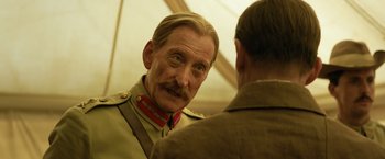Movie still from “The King's Man” (2021), directed by Matthew Vaughn – An older man in a military uniform talking to a younger man; Close Up shot, Over the shoulder angle