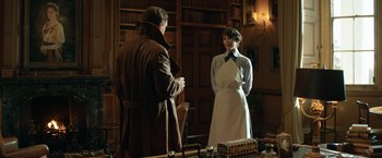 Movie still from “The King's Man” (2021), directed by Matthew Vaughn – A man and a woman standing next to each other in a room; Medium shot, Over the shoulder angle