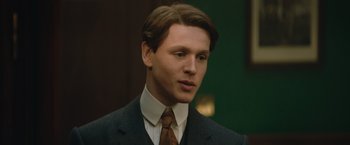 Movie still from “The King's Man” (2021), directed by Matthew Vaughn – A man in a suit and tie looking at the camera; Close Up shot, Low angle