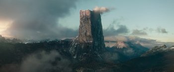 Movie still from “The King's Man” (2021), directed by Matthew Vaughn – A large rock formation in the middle of a valley; Extreme Wide shot, Low angle