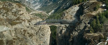 Movie still from “The King's Man” (2021), directed by Matthew Vaughn – A train traveling over a bridge in the middle of a valley; Extreme Wide shot, High angle