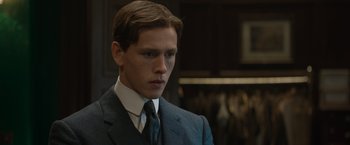 Movie still from “The King's Man” (2021), directed by Matthew Vaughn – A man in a suit and tie looking at the camera; Close Up shot, Low angle