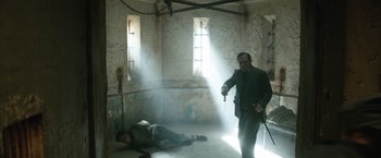 Movie still from “The King's Man” (2021), directed by Matthew Vaughn – A man is standing in the middle of a room; Wide shot, High angle